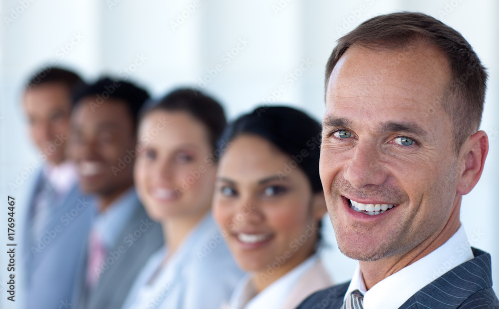 Attractive businessman in a row with his team Attractive businessman in a row with his team