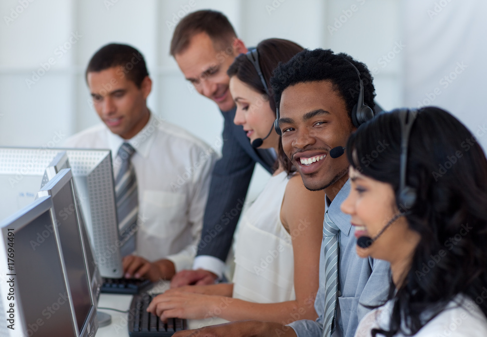 Manager talking to his business team in a call center Manager talking to his business team in a call center