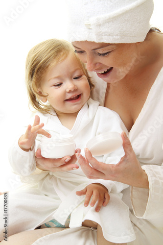picture of happy mother with baby holding cosmetic cream
