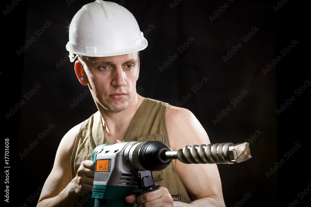 The builder in a protective helmet The builder in a protective helmet