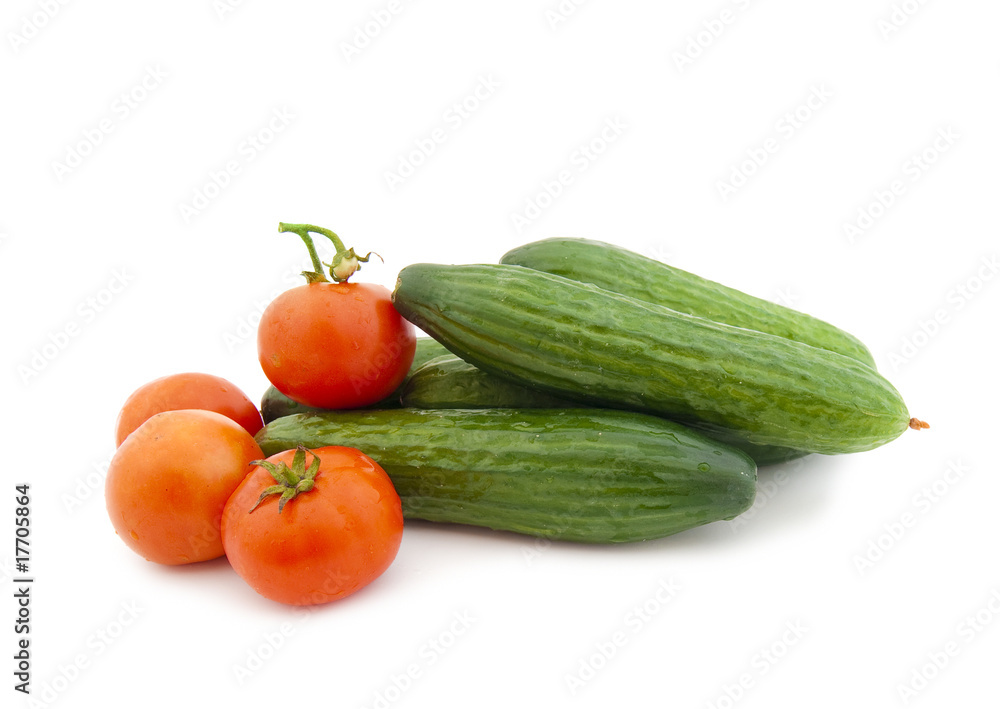 Ripe cucumbers and tomatoes on a white background