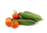 Ripe cucumbers and tomatoes on a white background