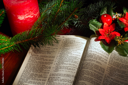 Bible open to Luke 2 Christmas text amid Christmas decor photo