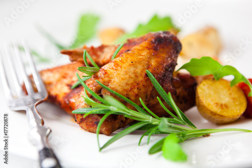 Roasted chicken wings with herbs and baked vegetables photo