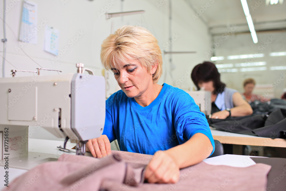 Tailor working at a textile factory Tailor working at a textile factory