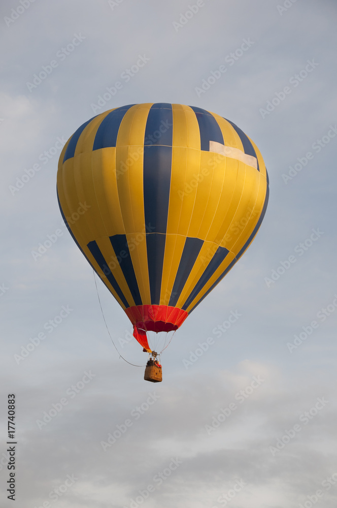 Fototapeta premium Colorful air balloon flies high in the sky