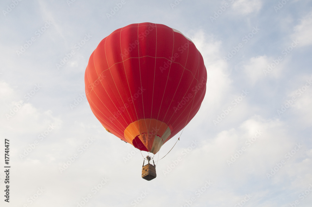Fototapeta premium Colorful air balloon flies high in the sky