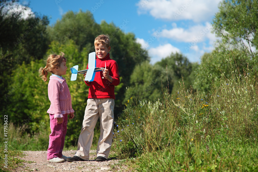 little girl and boy with toy airplane in hands outdoor little girl and boy with toy airplane in hands outdoor