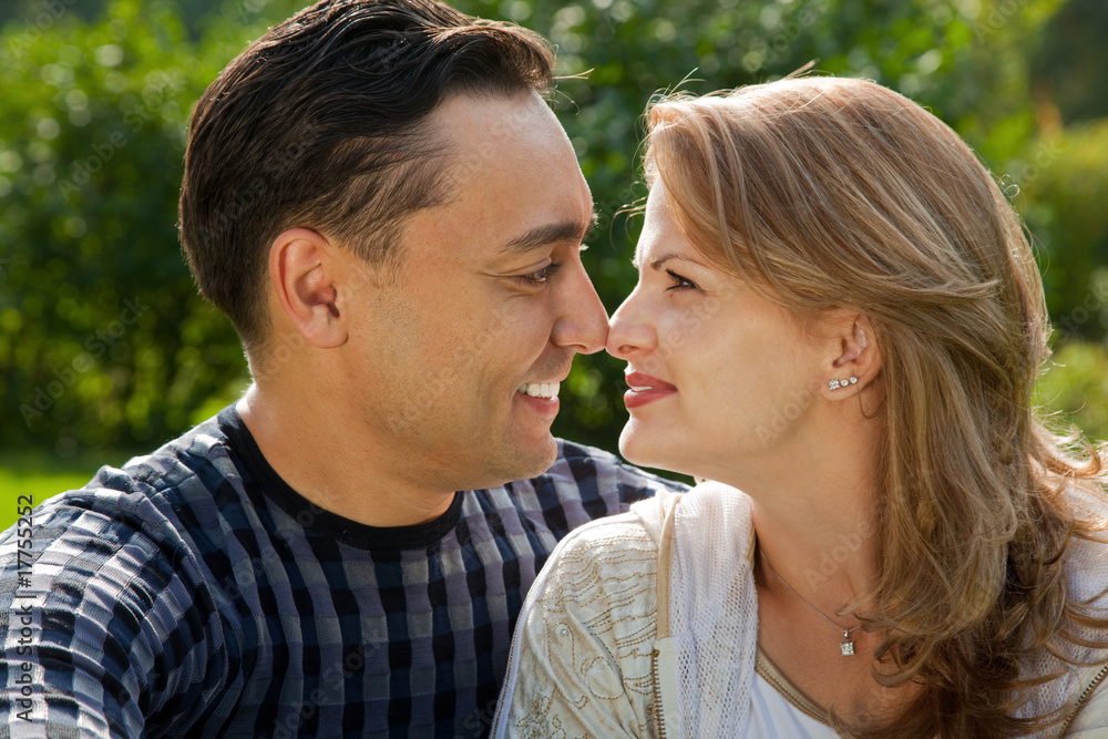 young loving couple face to face outdoors