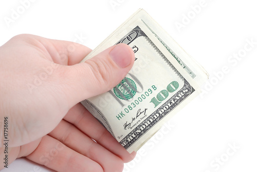 The hand holds dollars on white