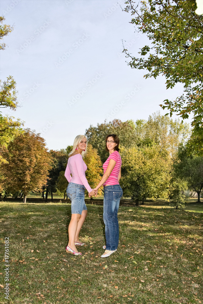 two sisters walking hand to hand