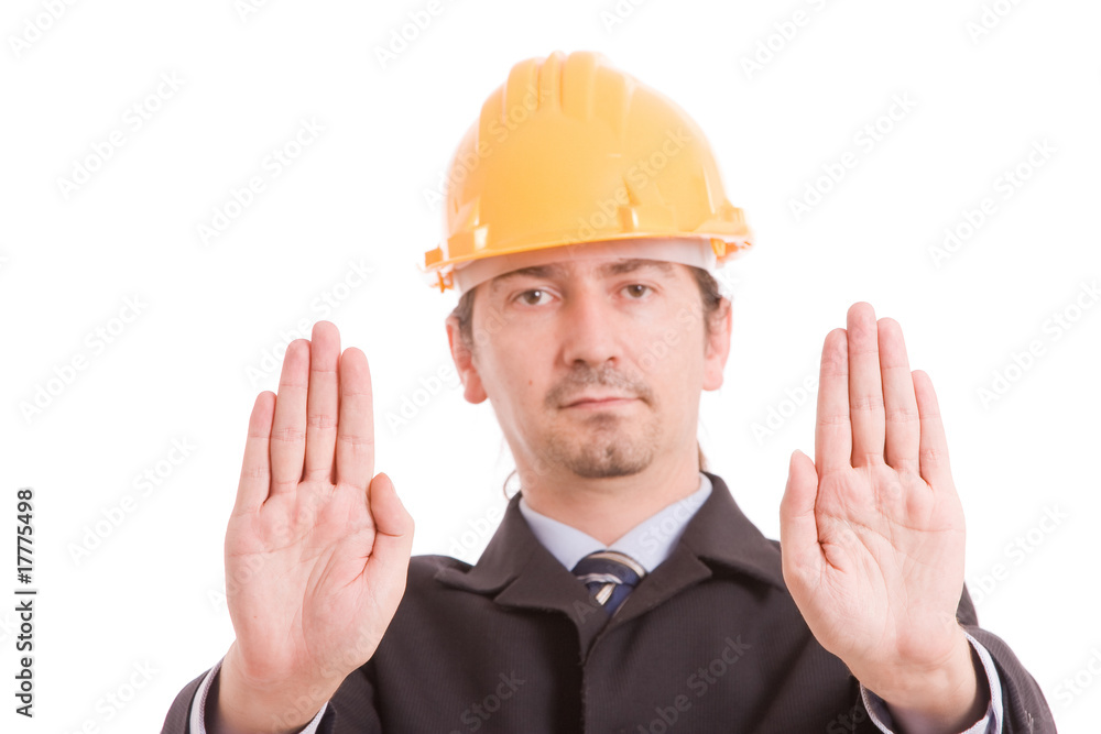Engineer with yellow hat making stop sign Engineer with yellow hat making stop sign