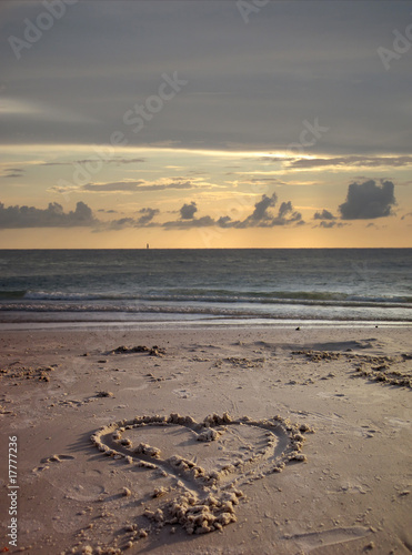 An image of heart shape drawing on the sand