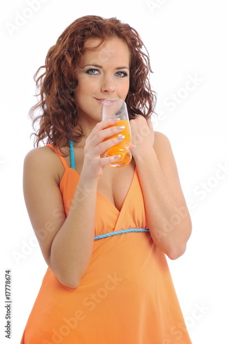 Beautiful young woman drinking orange juice