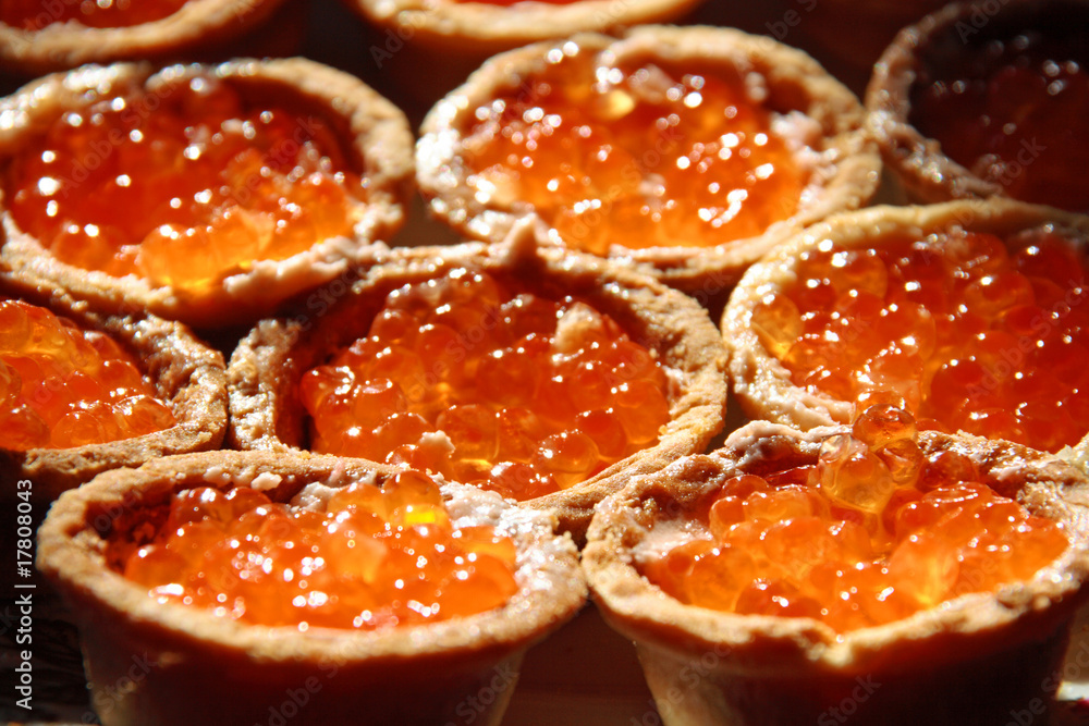 tartlet with red salmon caviar on a plate