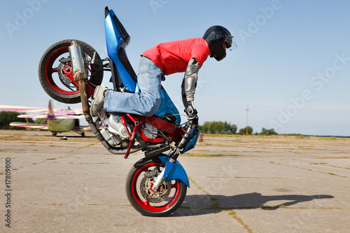 Stunt rider making stoppie photo