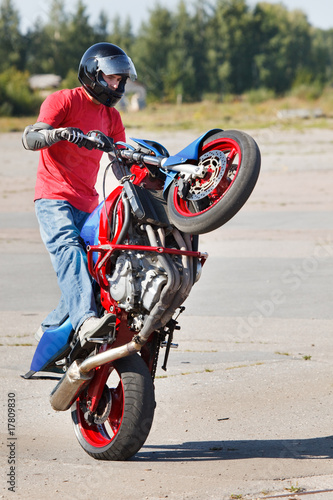 Stunt rider making wheelie