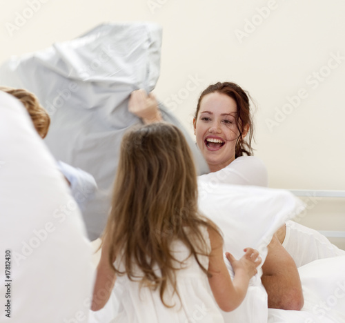 Mother and children having a pillow fight