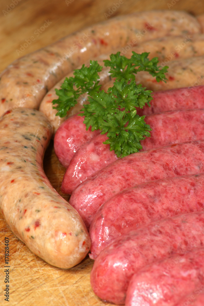 raw beef and pork sausages on a timber board raw beef and pork sausages on a timber board