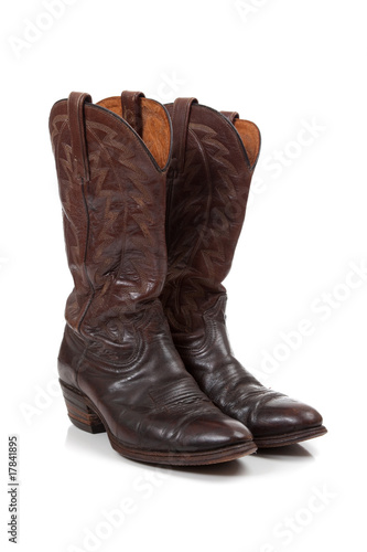 Brown leather cowboy boots on white