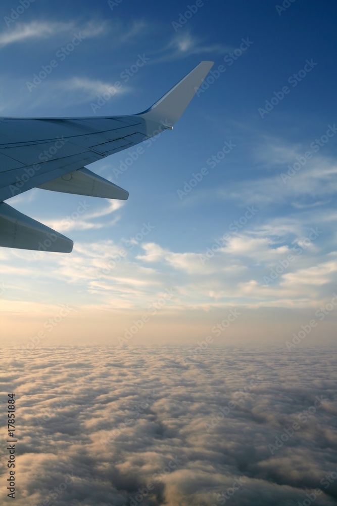 Aircraft right side wing, airplane flying in a blue sky Aircraft right side wing, airplane flying in a blue sky
