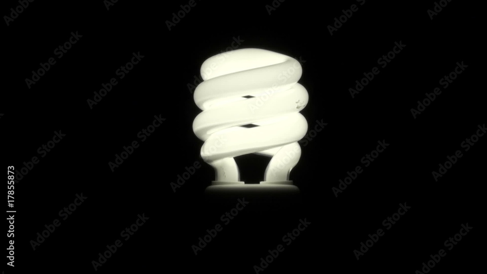 Energy saving light bulb goes on and off against black Energy saving light bulb goes on and off against black