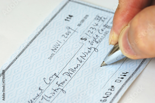 Writing a check to pay for the bill
