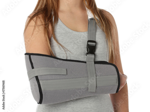 Woman wearing an arm brace over white
