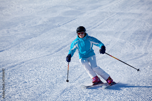 woman carving on groomed slope