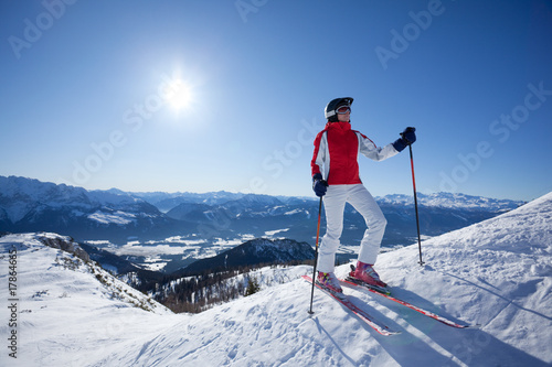 female skier on snowy hill at sunshine