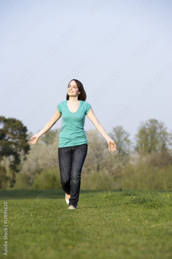 Teenage Girl Running Through Summer Meadow