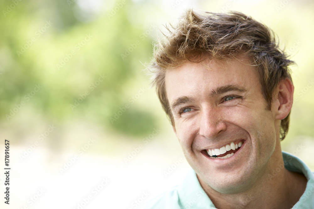 Portrait Of Young Man Sitting In Park Portrait Of Young Man Sitting In Park