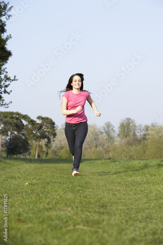Teenage Girl Running Through Summer Meadow © Monkey Business
