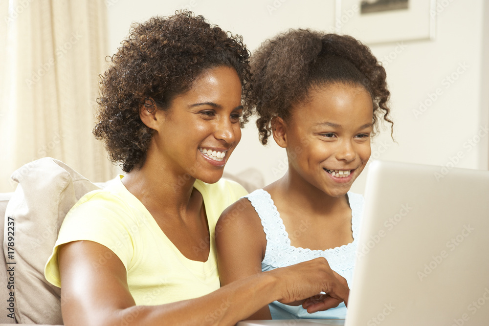 Mother And Daughter Using Laptop At Home Mother And Daughter Using Laptop At Home