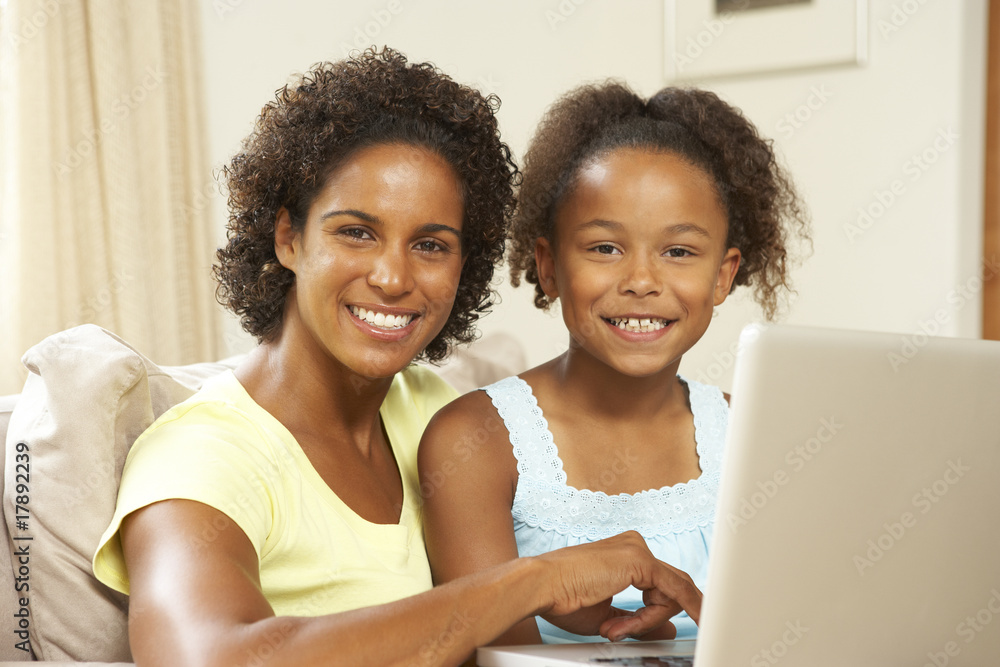 Mother And Daughter Using Laptop At Home Mother And Daughter Using Laptop At Home