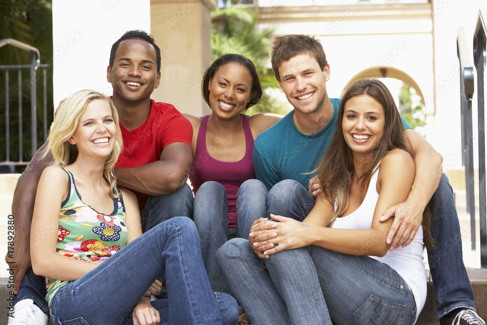 Group Of Friends Sitting On Steps Of Building Group Of Friends Sitting On Steps Of Building