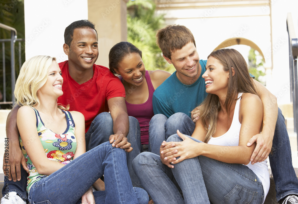 Group Of Friends Sitting On Steps Of Building Group Of Friends Sitting On Steps Of Building