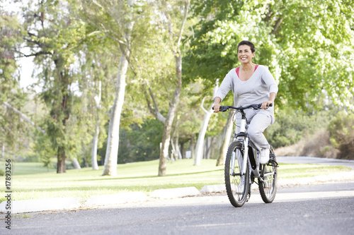 Senior Woman Cycling In Park