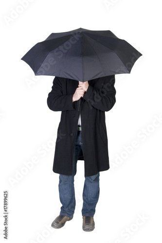 Man hiding his face under a black umbrella (isolated on white)