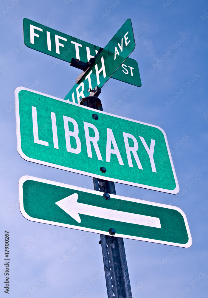 Fototapeta premium A directional roadsign to the library.