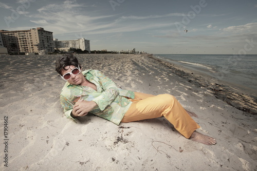 Funky man laying on the sand