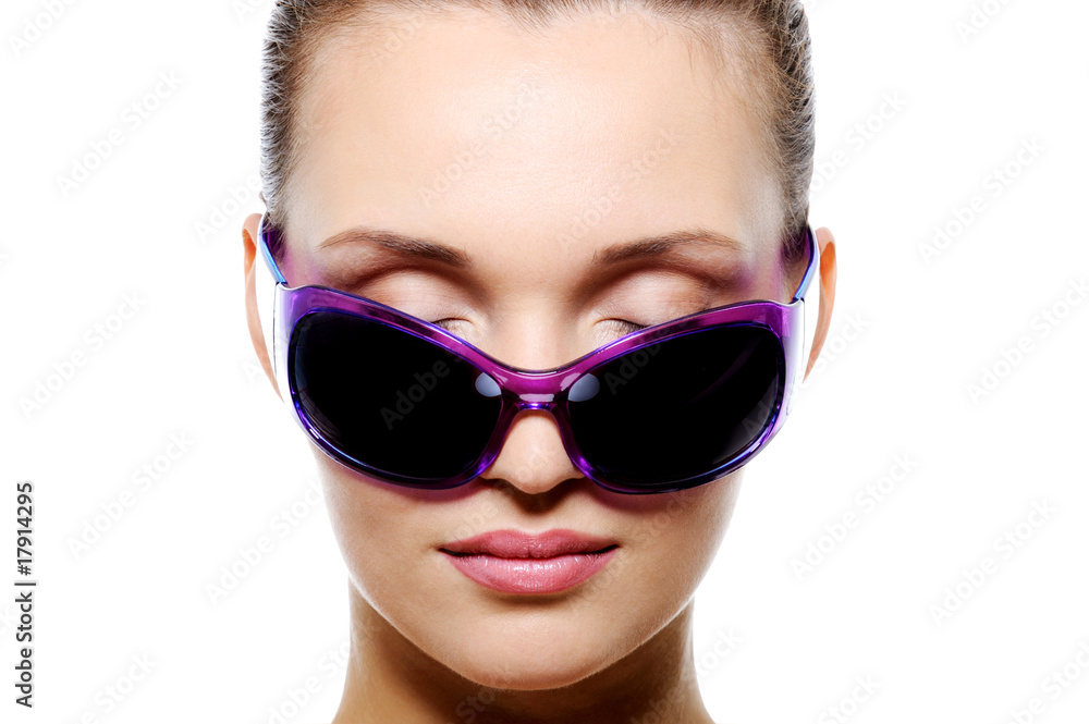 Front view of female face in dark violet sunglasses Front view of female face in dark violet sunglasses