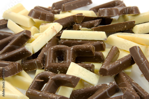 White and brown chocolate candy letters in closeup photo