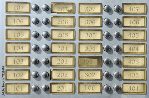 Apartment house doorbell plate with numbers photo