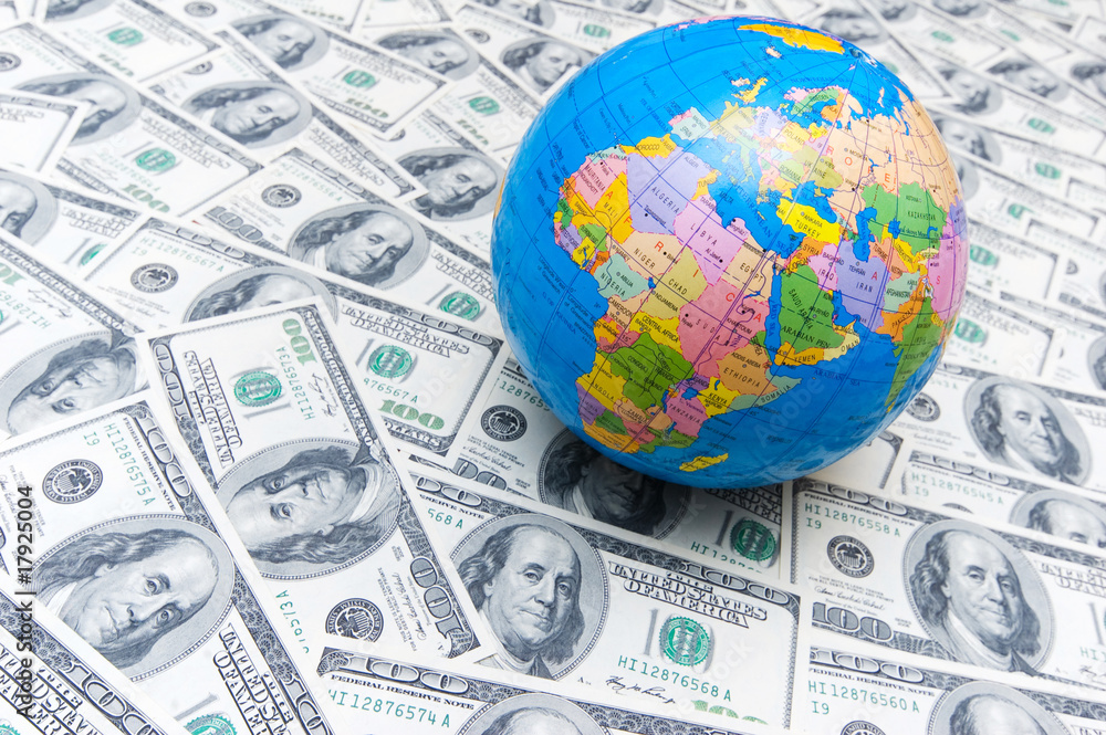Globe over many american dollar bank notes Globe over many american dollar bank notes