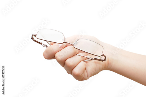 Glasses in a female hand isolated