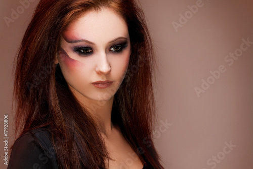 young beautiful brunette woman with artistic makeup
