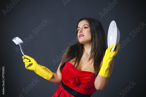 Abstract image of a glamorous housewife doing the dishes. photo