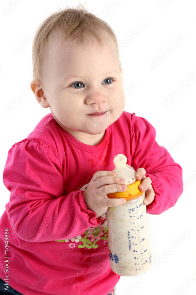 Beautiful little baby girl in a pink jacket with small bottle Beautiful little baby girl in a pink jacket with small bottle
