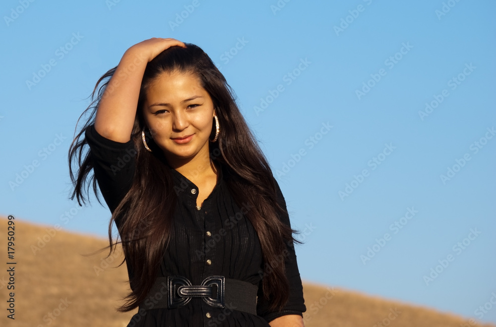 Young beautiful asian woman at the sunset in the mountains Young beautiful asian woman at the sunset in the mountains